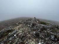 Brewery Knob surrounded in fog, with a pile of rocks in the centre