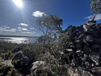 A pile of rocks on the right side, a big lake in the background
